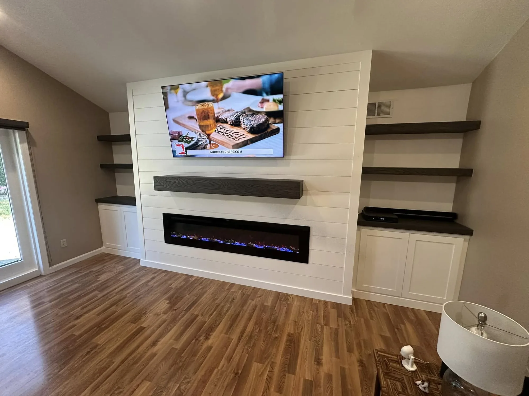 Media Wall with Floating Shelves — custom carpentry by Custom Interiors & Remodeling