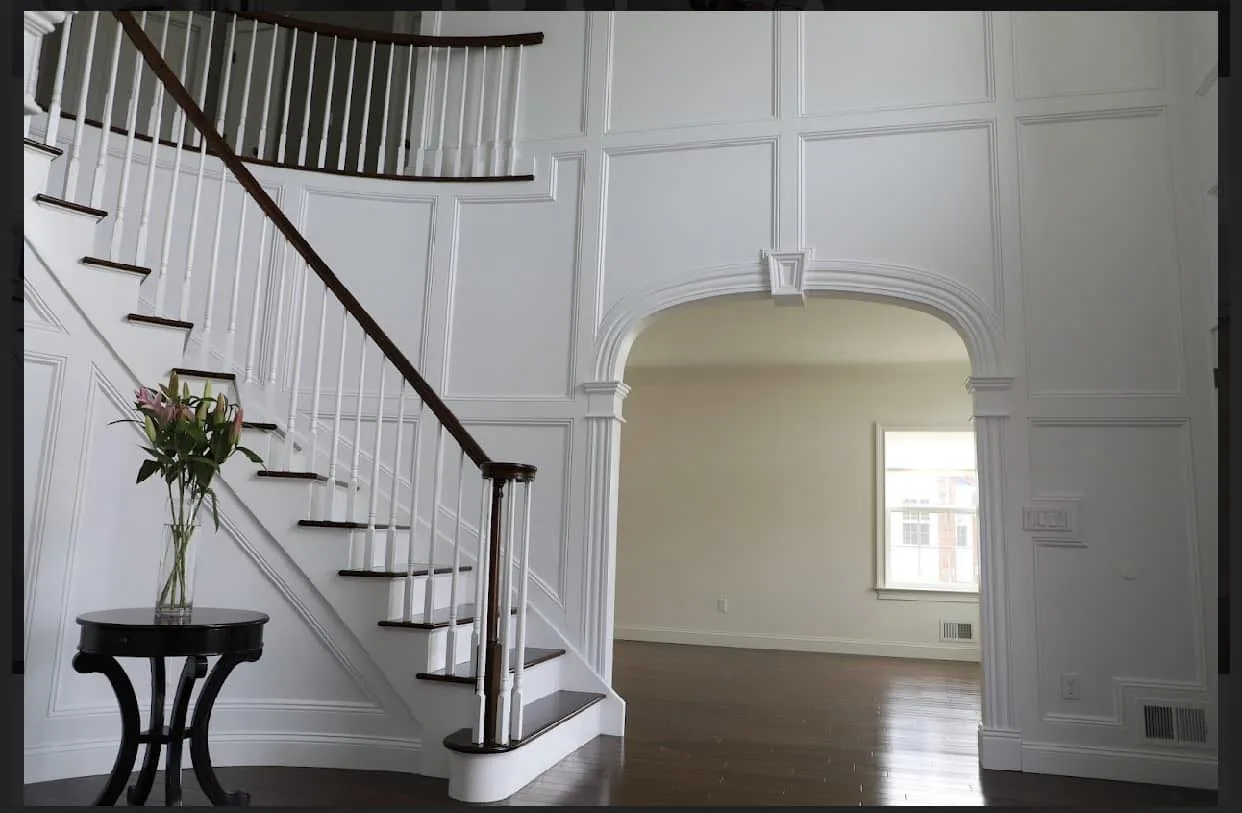 Curved Stair, Panelled Walls — custom carpentry by Custom Interiors & Remodeling
