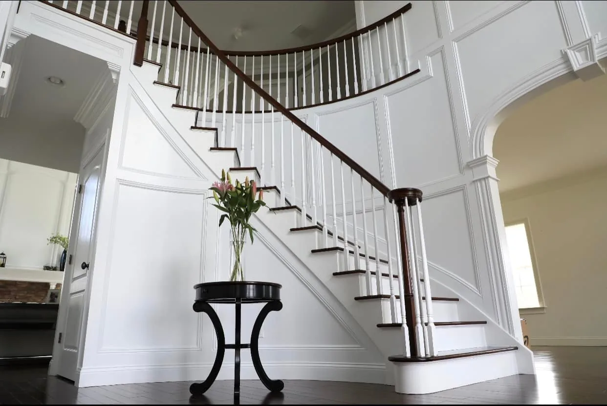 Two-Storey Foyer & Curved Stair — custom carpentry by Custom Interiors & Remodeling
