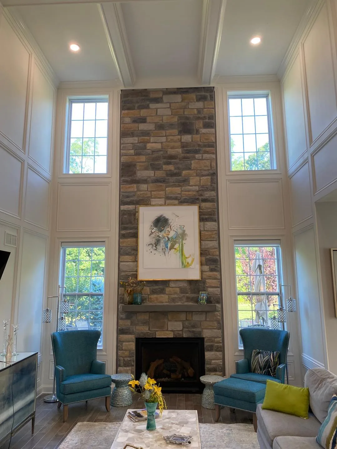 Two-storey stone fireplace with custom millwork